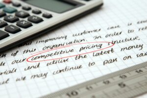 Competitive Pricing Circled on a Page with Calculator, preschool value