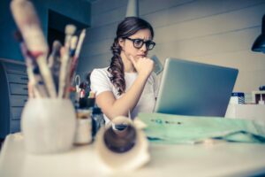 Woman Conducting Research on Laptop, preschool tuition